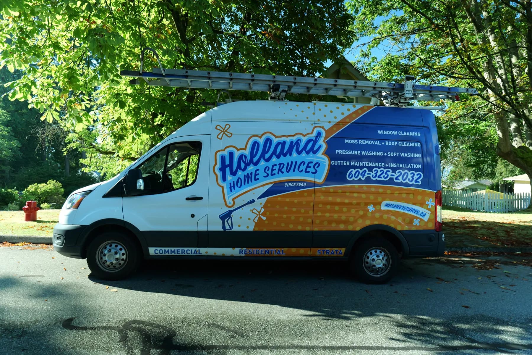 Holland Home Services branded van parked on a Greater Vancouver street